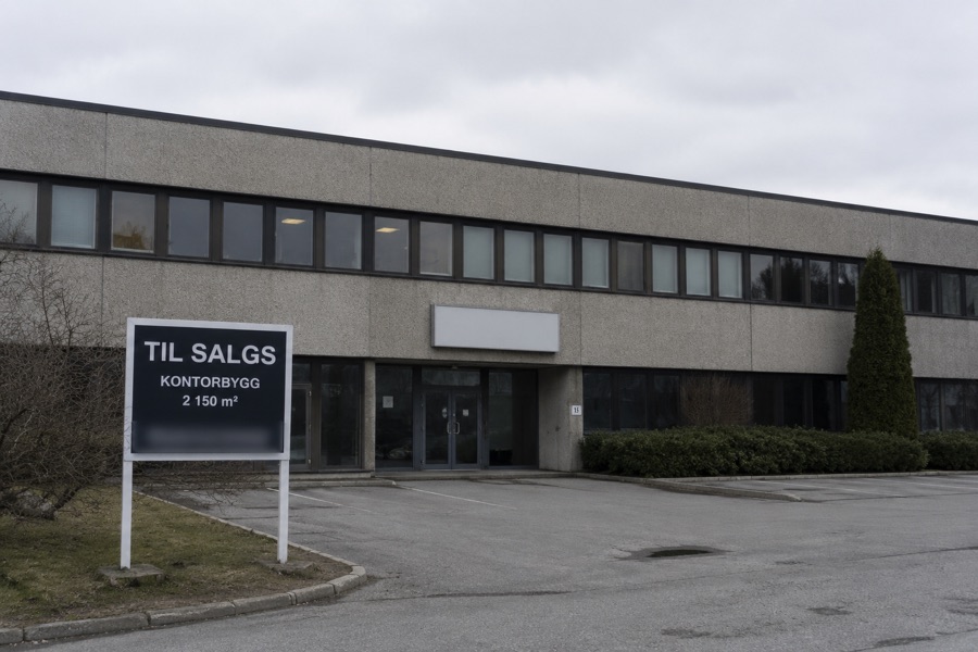 Kontorbygg med TIL SALGS-skilt utenfor